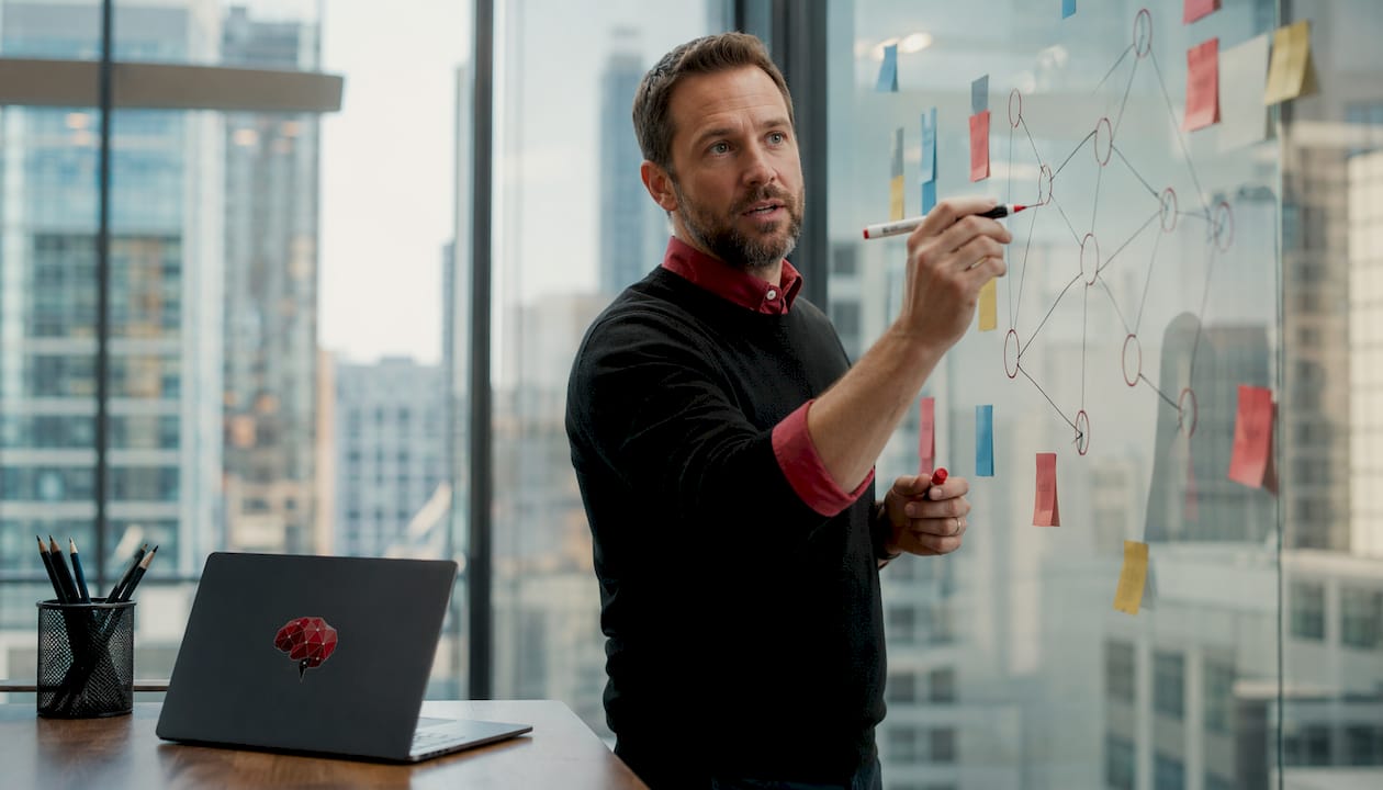 Man explaining workflow orchestration on whiteboard