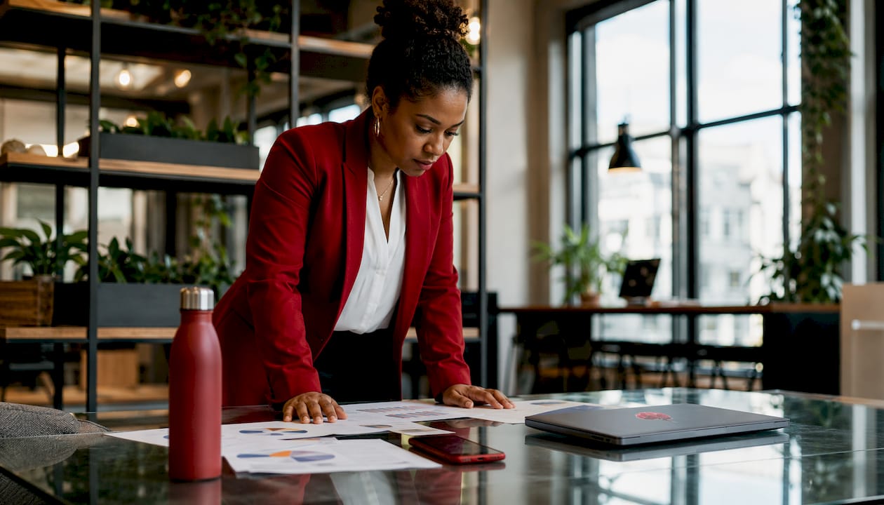 Analyst reviewing printed data charts in office