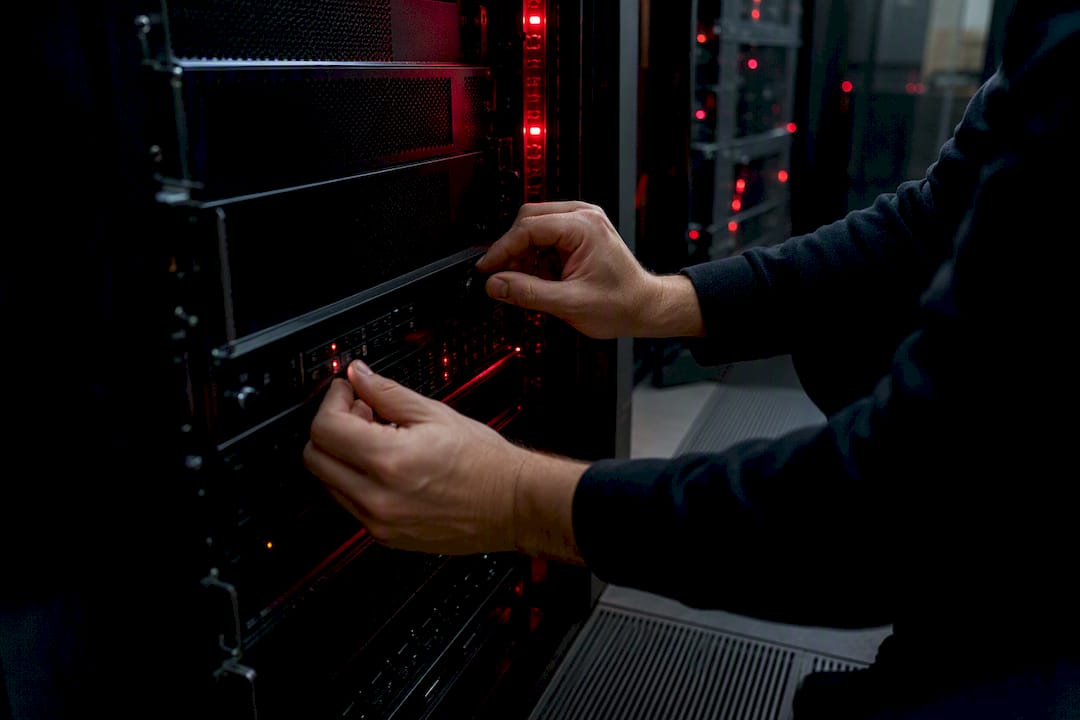 Hands adjusting server hardware controls