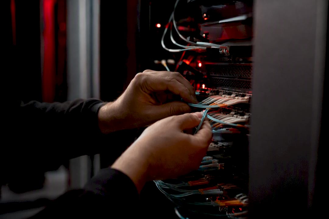 Technician hands connecting fiber optic cables