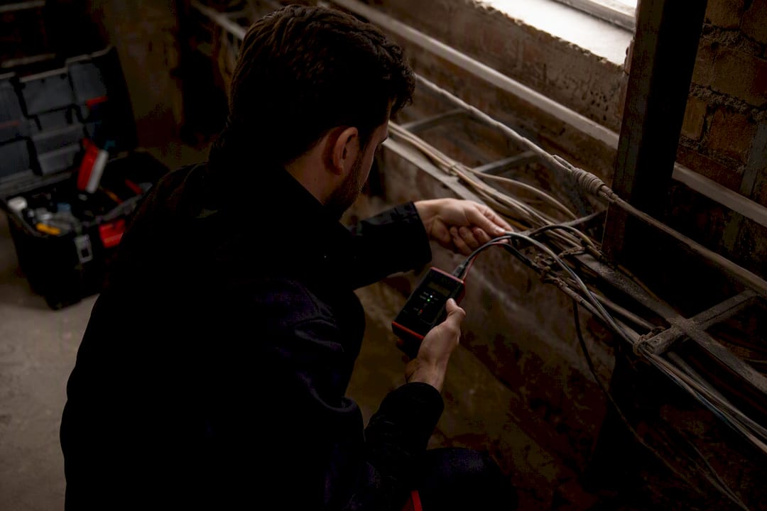 Hands inspecting legacy network wiring
