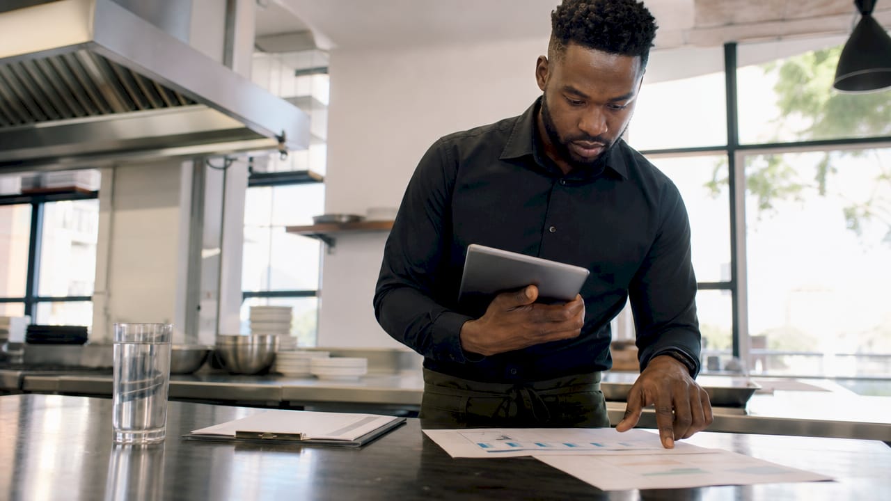 Manager checking restaurant data accuracy