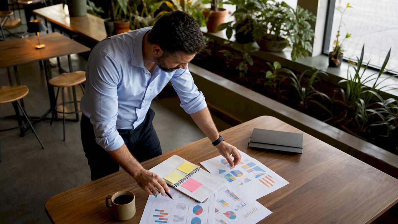 Restaurant manager reviewing menu analytics at desk