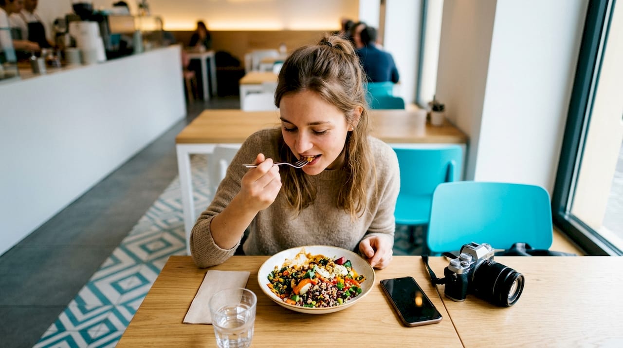 Female micro influencer tasting dish at restaurant