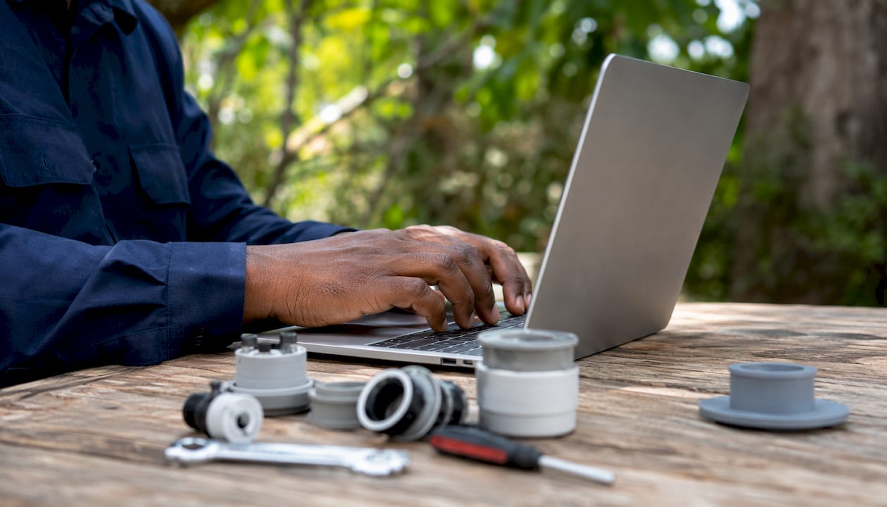 Hands typing on laptop for appliance parts lookup