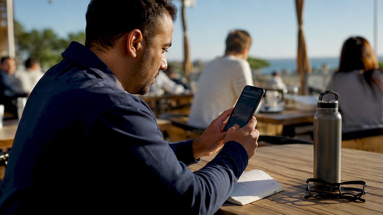 Hands holding smartphone tracking payment transaction