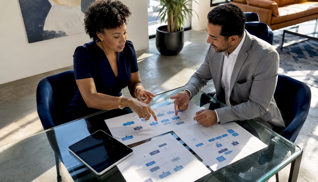 Two professionals discussing payment processing