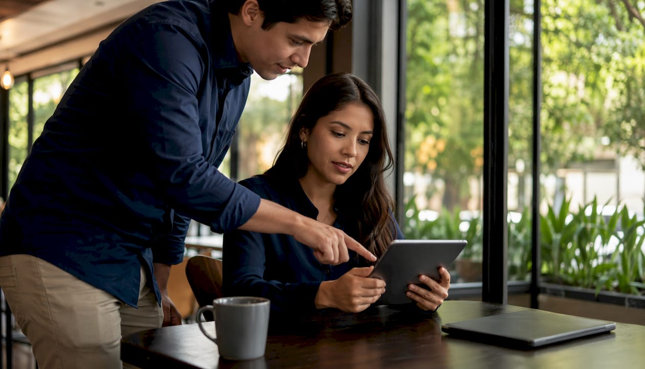 Engineer reviewing financial data on tablet