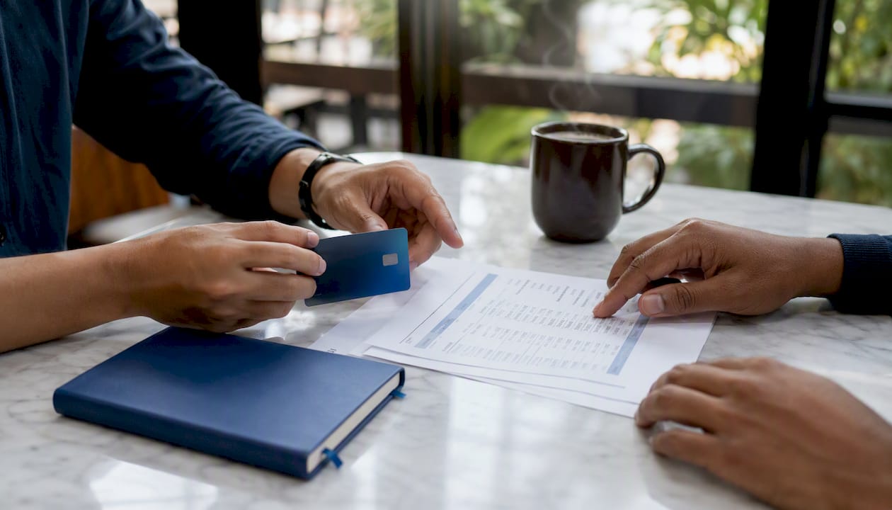 Hands managing startup spend report and card