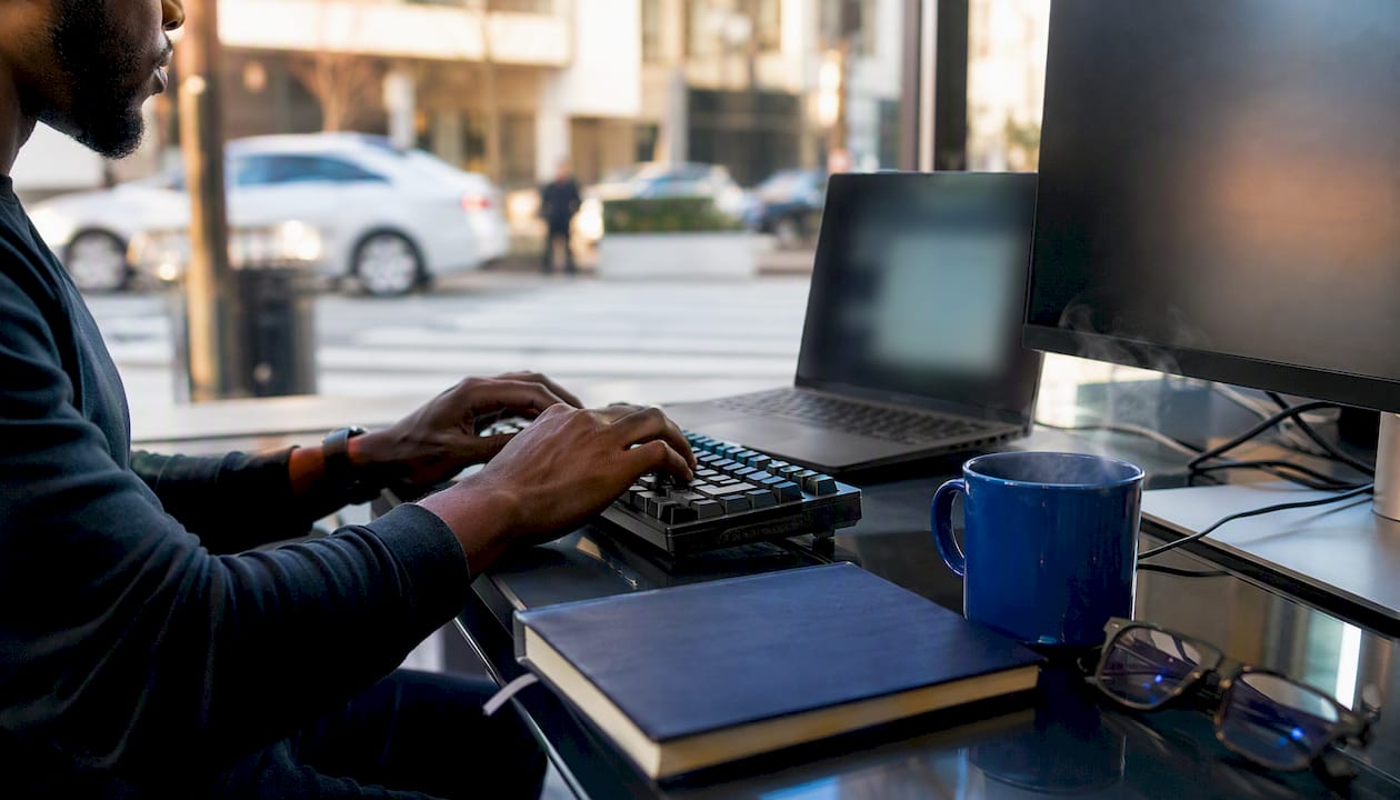 Close-up of hands coding integration design at desk