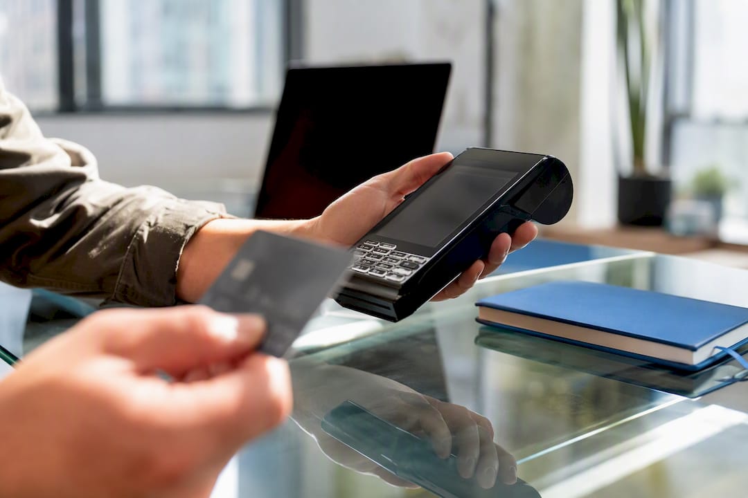 Hands performing card validation with calculator