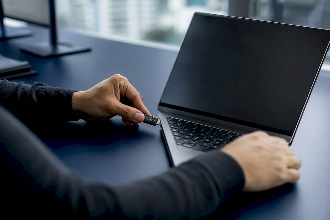 Hands inserting security token for multi-factor authentication