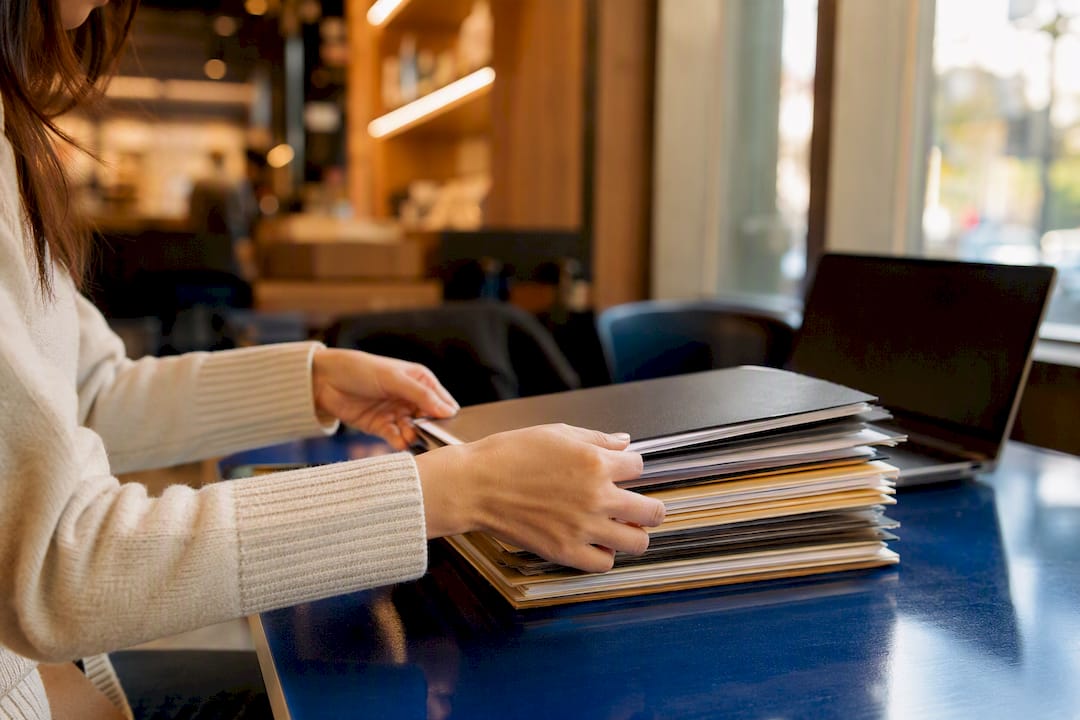 Hands organizing compliance digital records