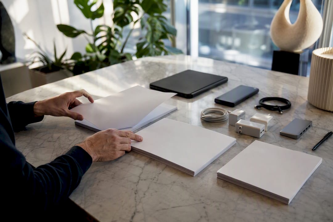 Hands arranging compliance tools in fintech office