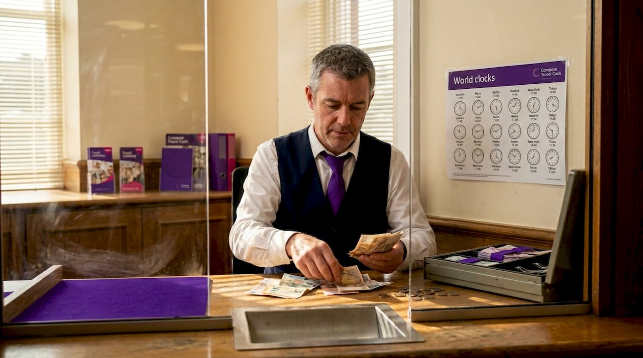 Bank teller sorting different currency notes