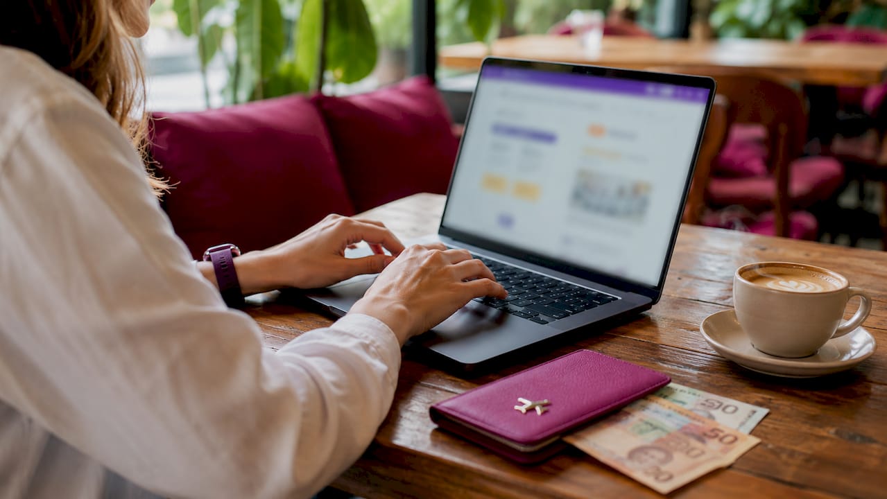 Hands using laptop for currency exchange online
