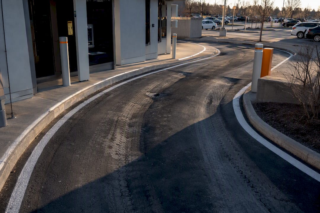 Rutted asphalt in bank branch drive-thru lane