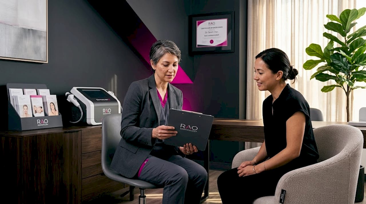 Dermatologist consulting with patient at clinic desk