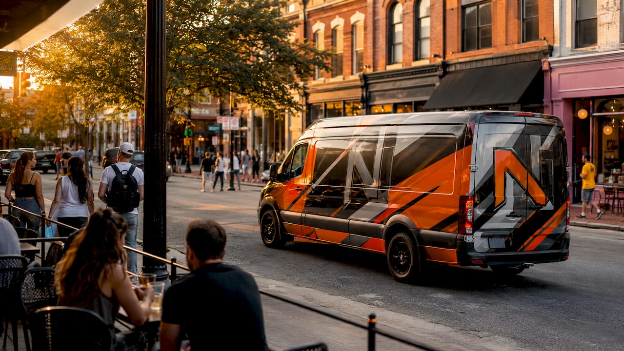 Branded delivery van driving in city street