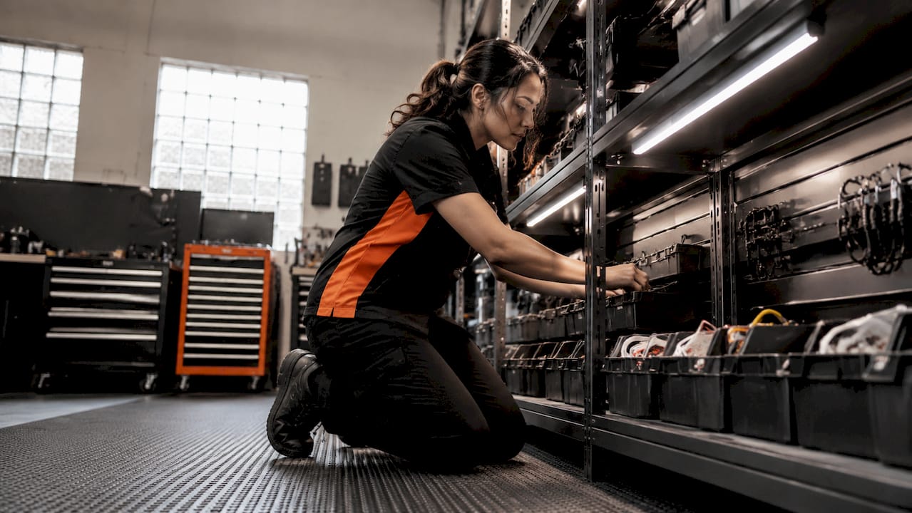 Technician organizing upfit shelving inside van