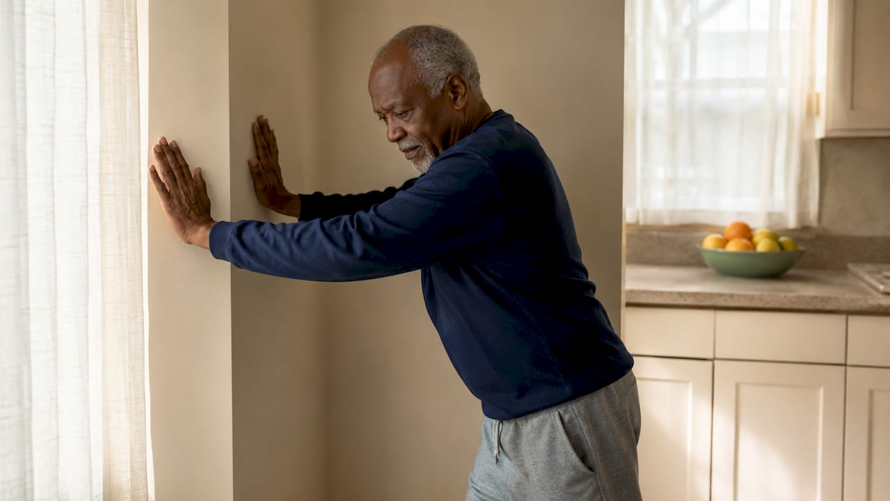 Senior man practicing corner stand exercise