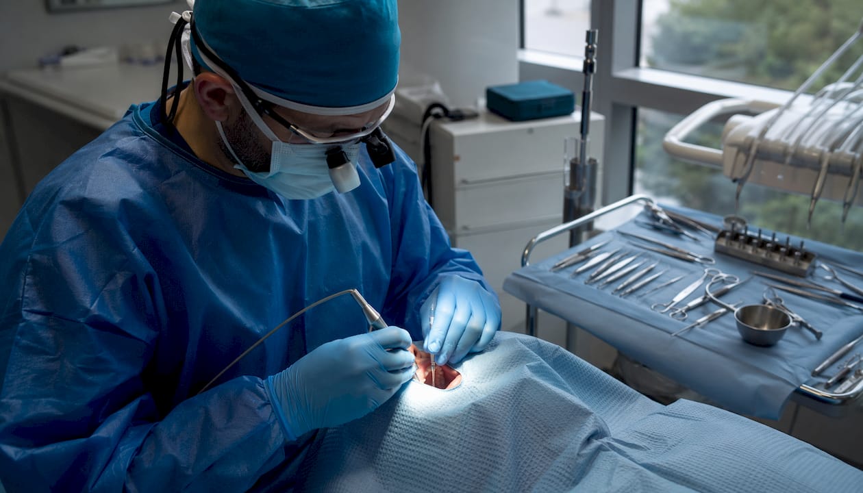 Dental surgeon performing implant surgery