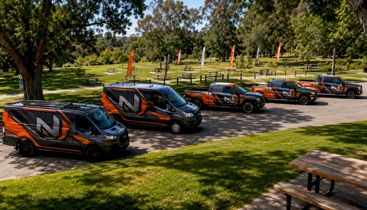 Fleet of branded commercial vehicles parked outdoors