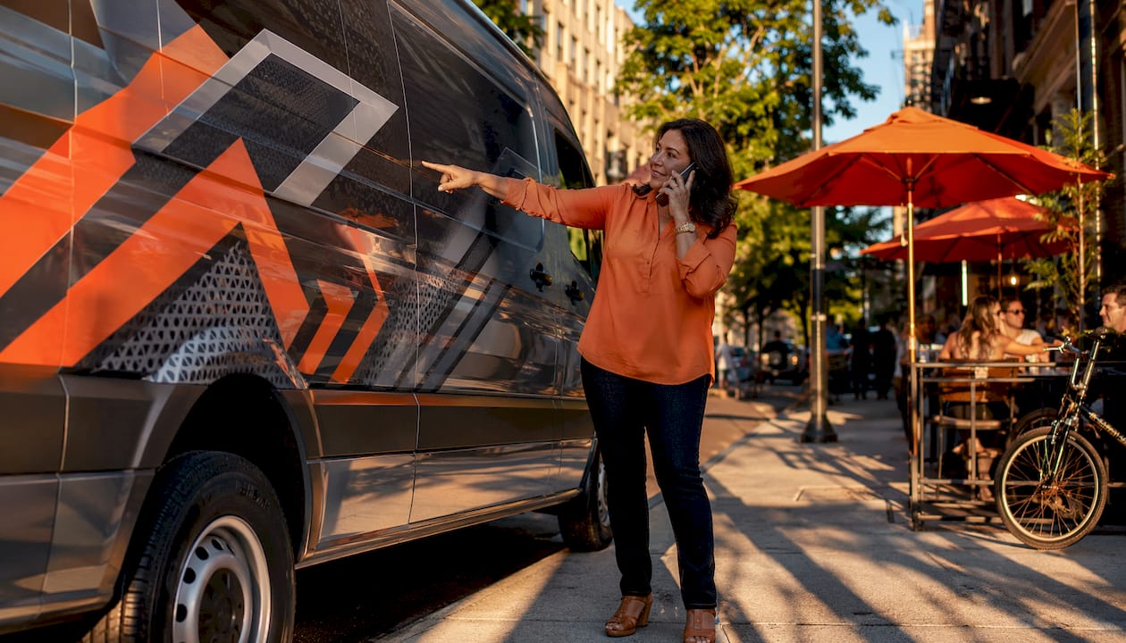 Business owner showcasing full wrap on delivery van