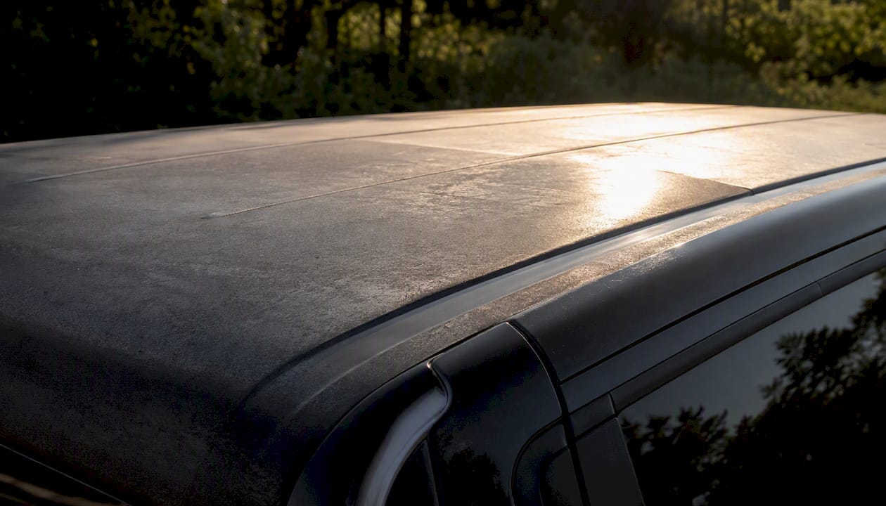 Faded vehicle wrap on sun-exposed roof panel