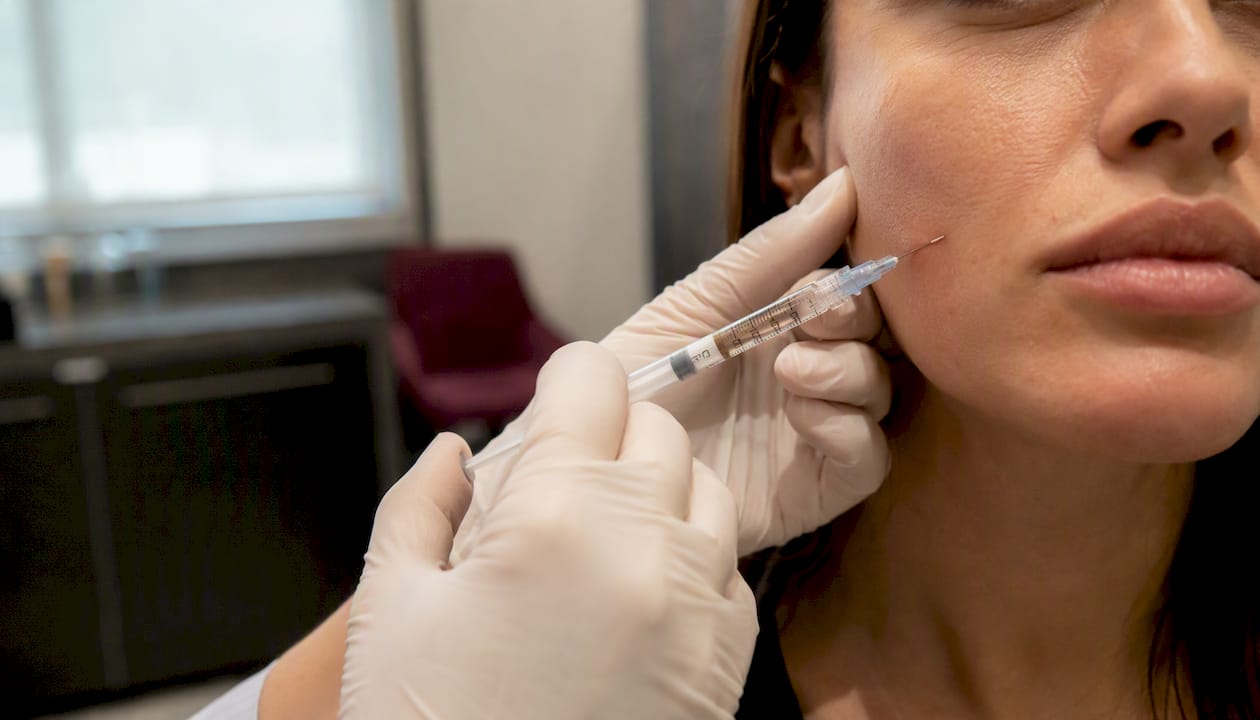 Close-up of filler injection on face