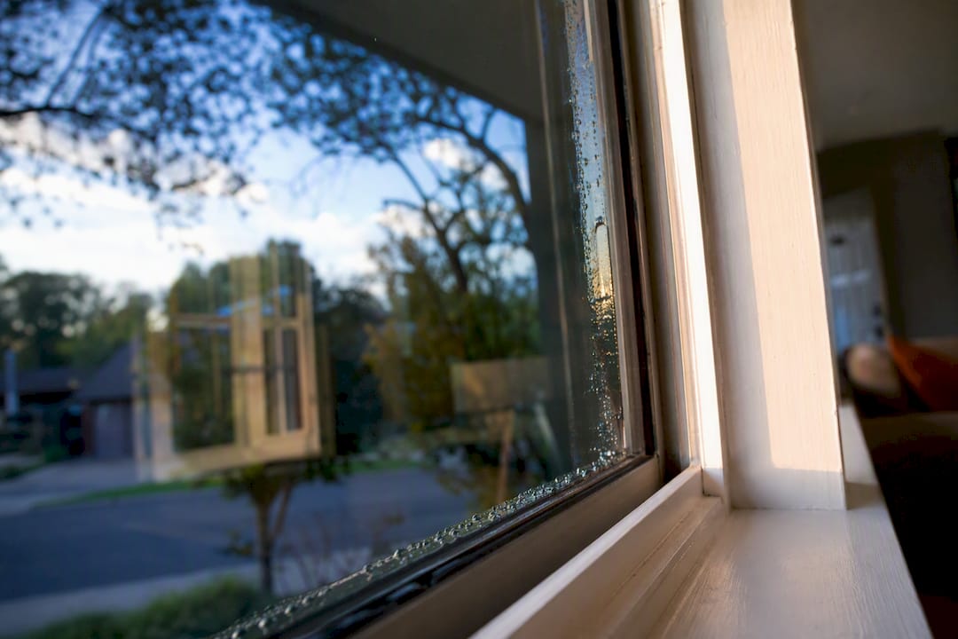 Close-up of window tint edge with bubbles on residential glass
