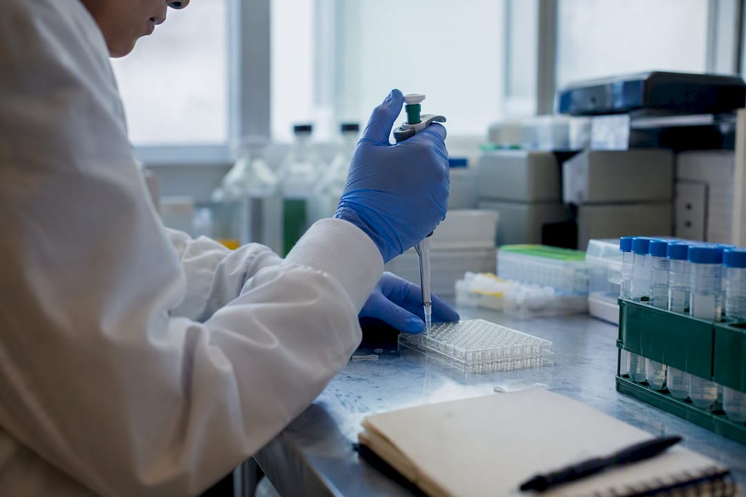 Hands pipetting samples in clinical lab