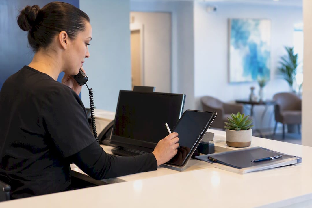 Clinic receptionist scheduling appointment by phone