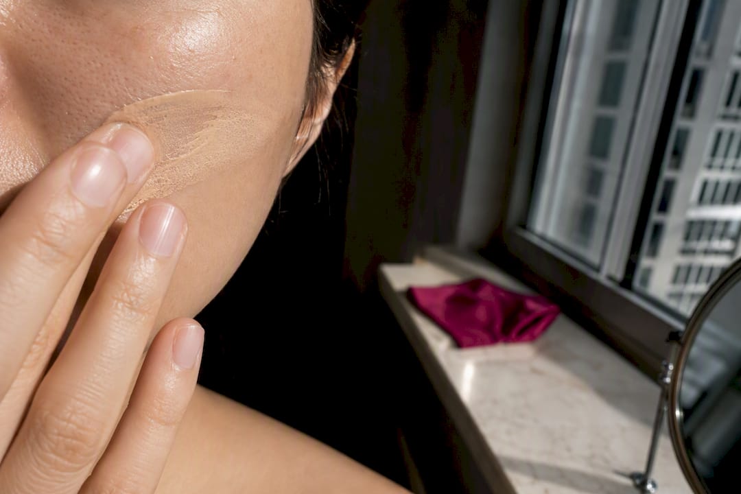 Tinted sunscreen applied across cheek