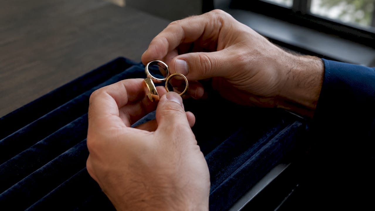 Hands comparing vermeil, gold-filled, and gold-plated rings