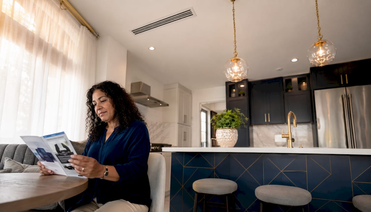 Homeowner reviewing forced air heating types brochure