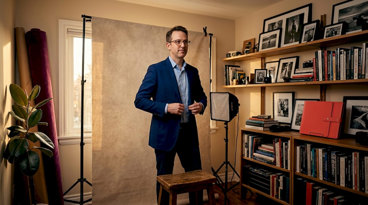 Man adjusting headshot background in workspace