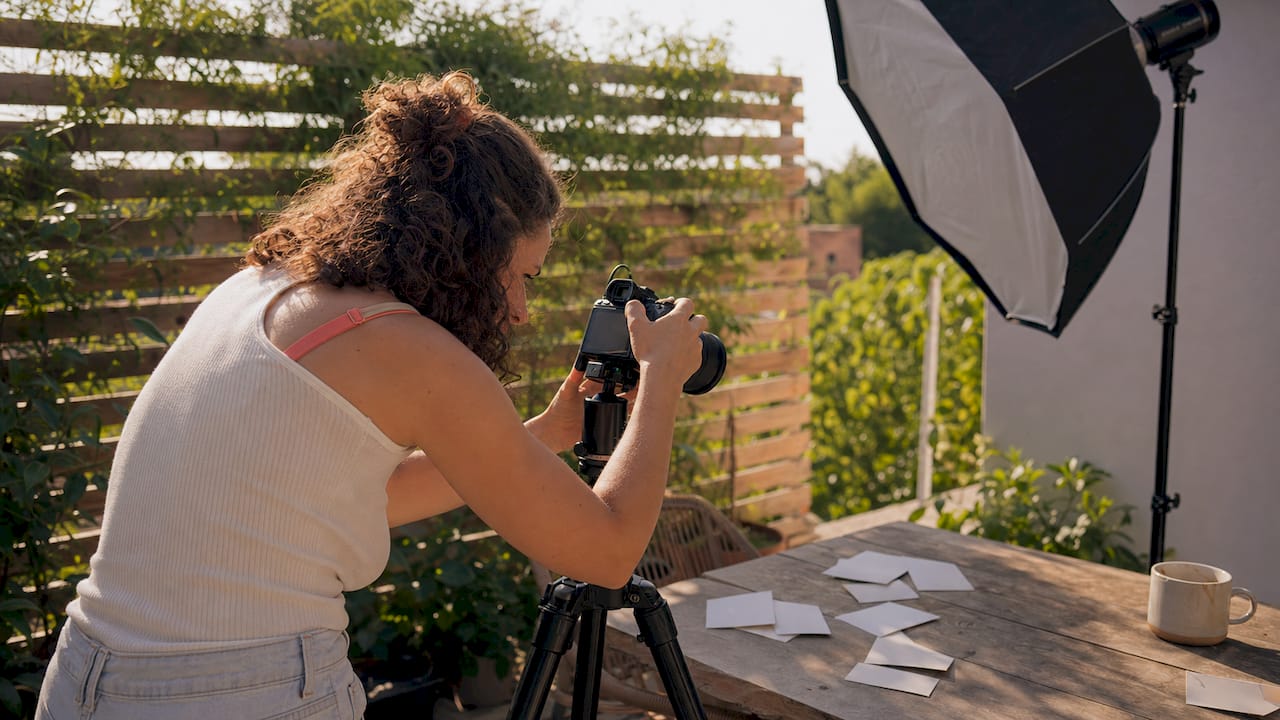 Photographer adjusting camera in headshot studio