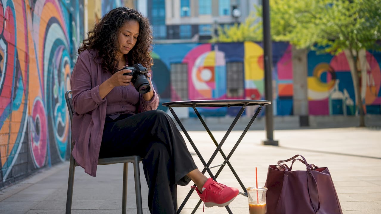 Photographer reviewing authentic brand photos in cafe