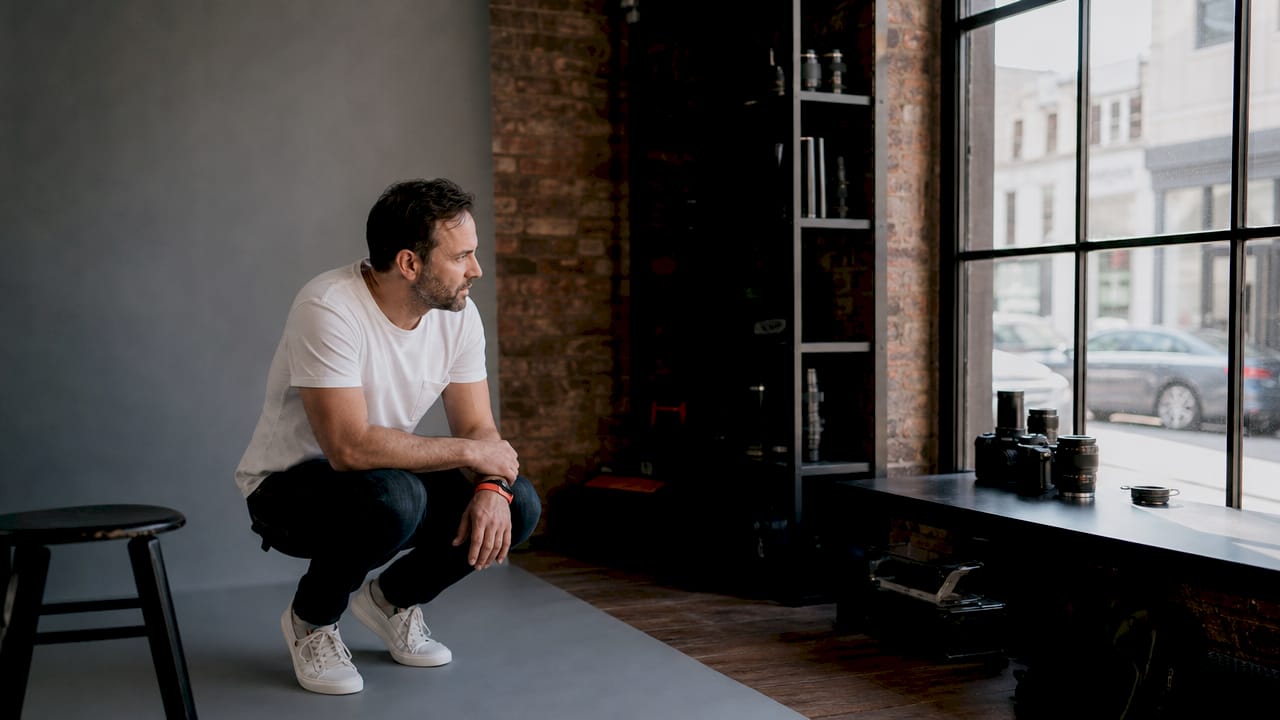 Photographer adjusting lighting in studio
