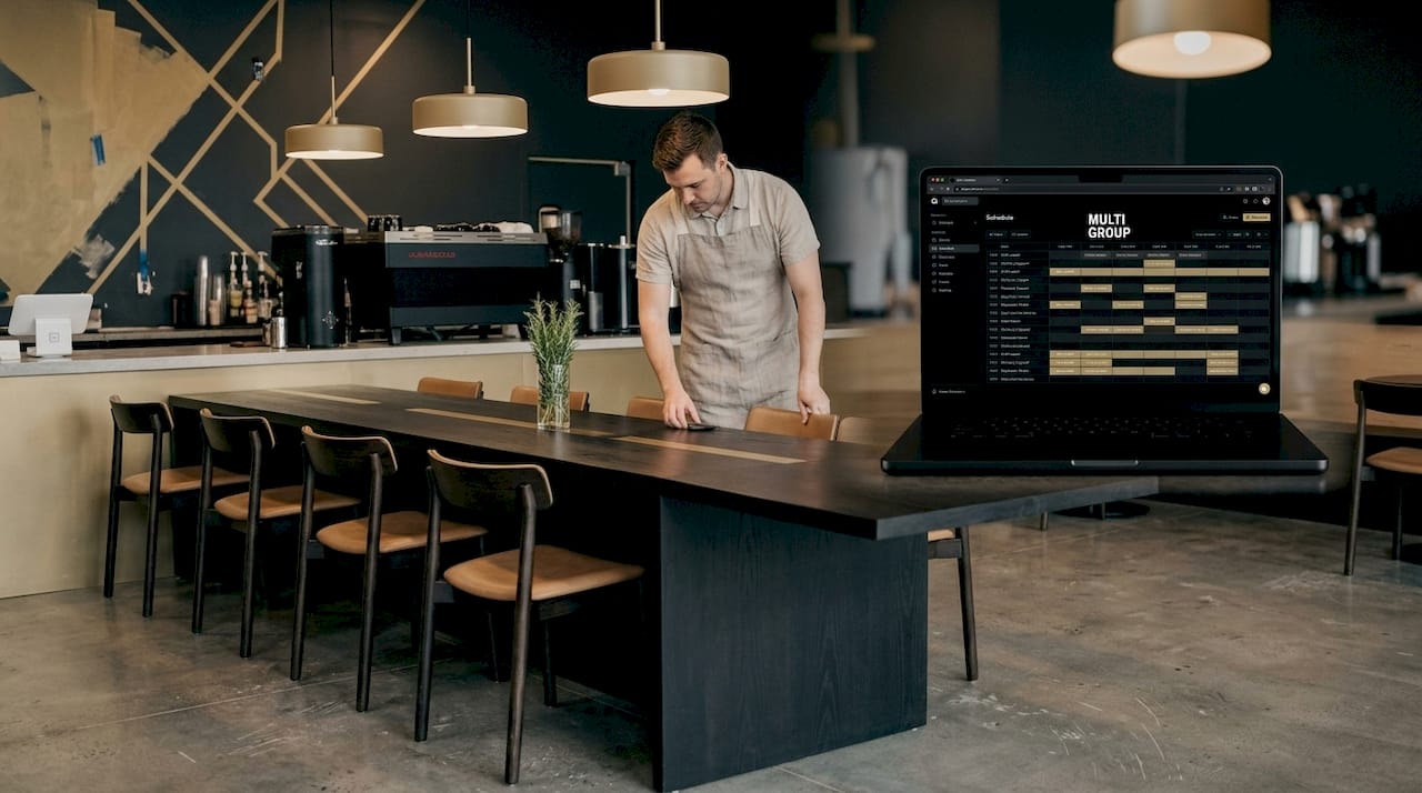 Barista prepares seating in renovated coffee shop