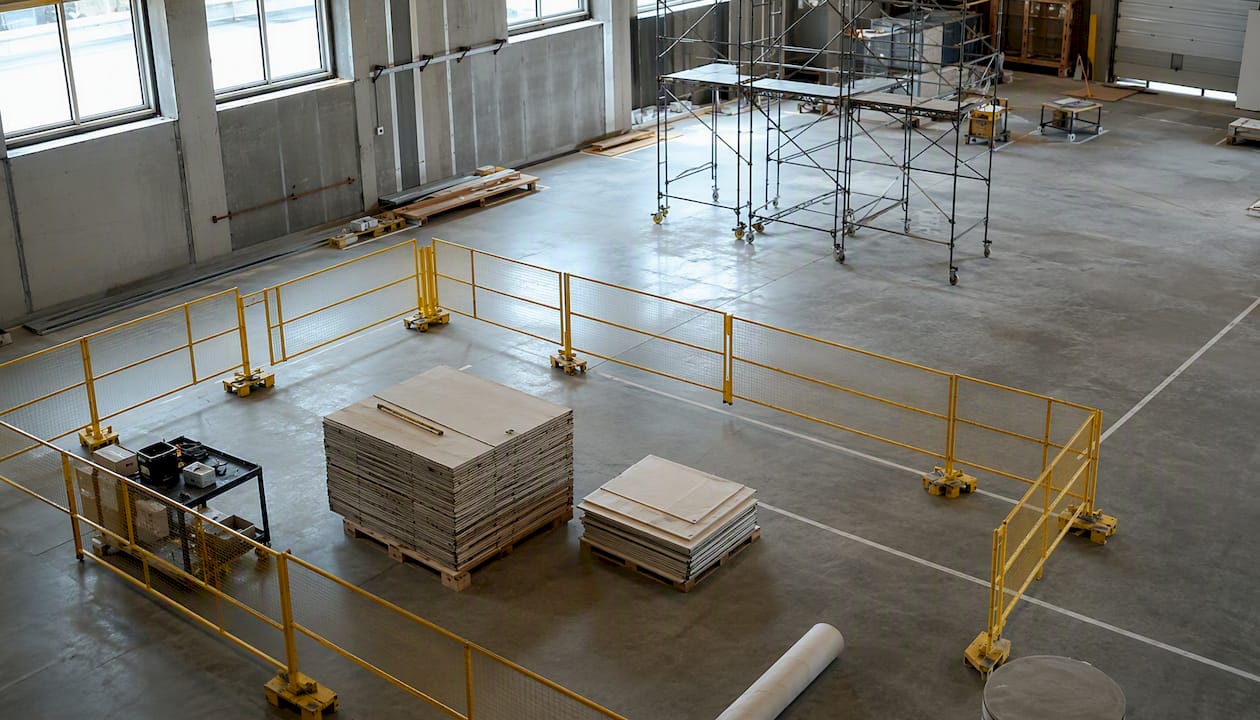 Dark warehouse under renovation with industrial materials