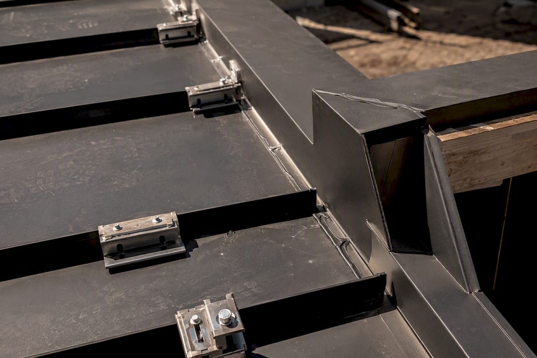 Close-up of metal roof fasteners and flashing details