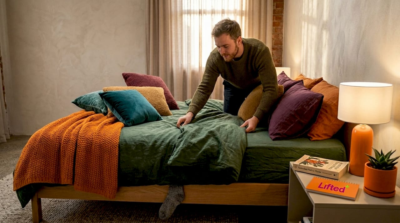 How to create real aesthetic presence in your home 2 Man arranging layered bedding in cozy bedroom