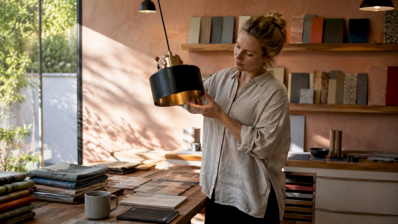 How to select statement lighting for your home 2 Designer assessing pendant light fixture style and finish