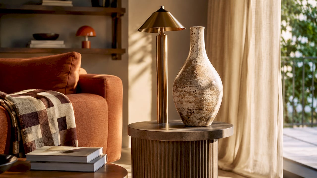 Why opt for sculptural accents in your home 3 Close-up of sculptural lamp and pottery on coffee table