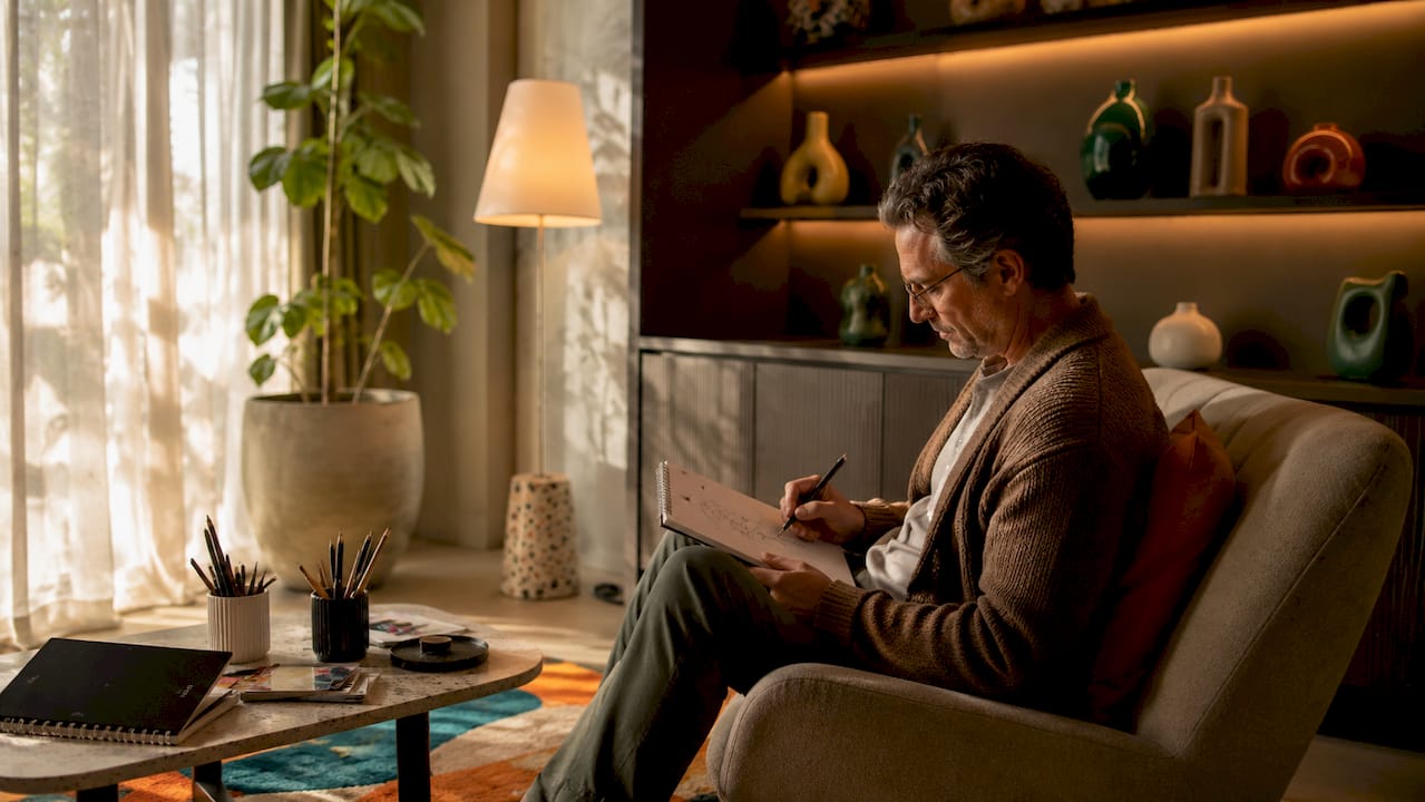 Mood led interiors: how light shapes your home 3 Man working under layered lighting in home study