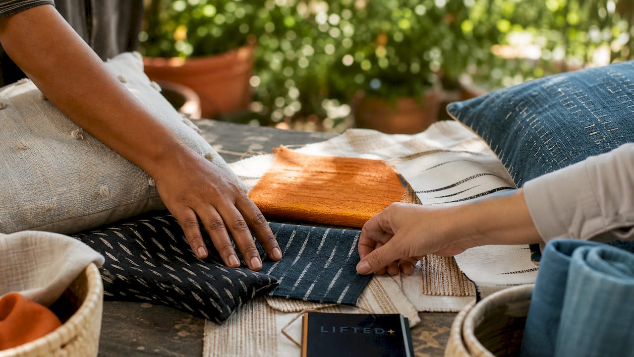 How to add texture to a rental home: a practical guide 3 Hands arranging textile samples on table
