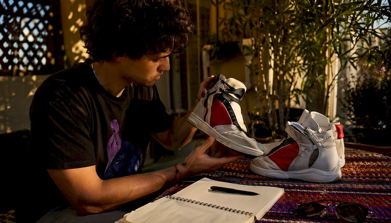 Hands comparing screen accurate movie shoes