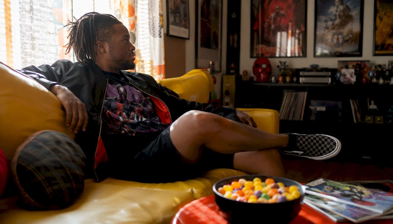 Side view of man in fandom casual outfit on couch